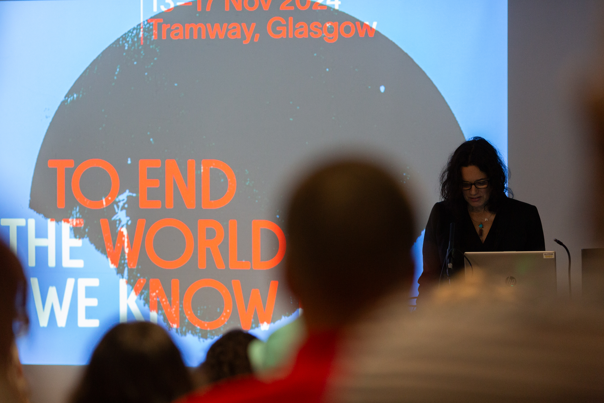 Leanne Betasamosake stands in front of an audience delivery a talk.
