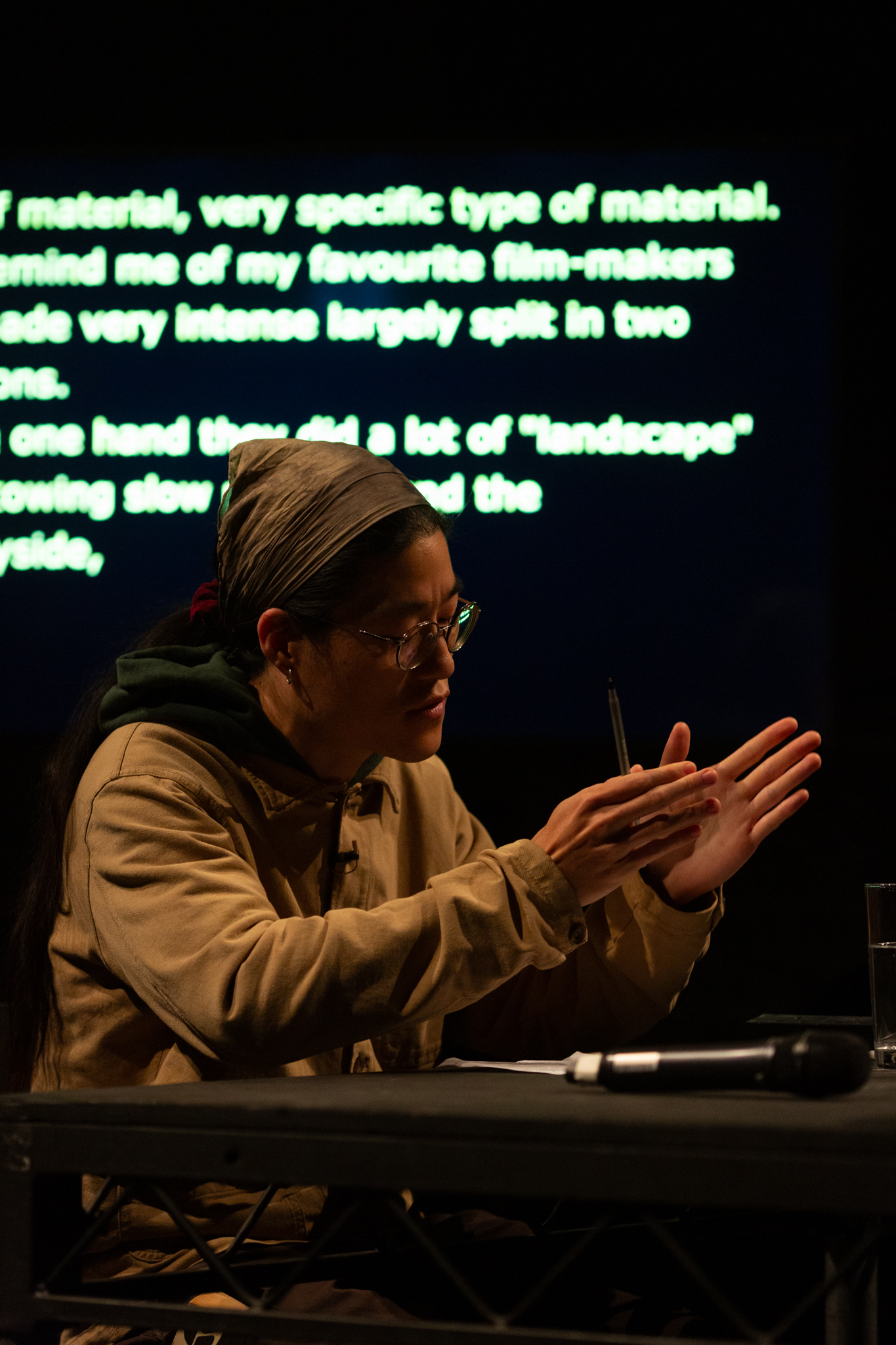 Sunik Kim talks expressively gesturing with their hands held infront of them.