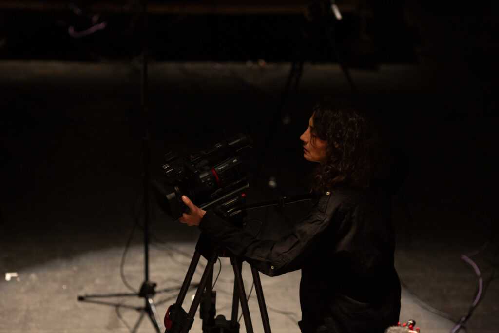 Someone operates a large video camera