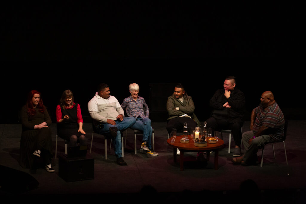 Karrabing Film Collective and Elwood Jimmy are star on stage in a discussion event. Elizabeth A Povinelli is laughing while the others smile. To the right of them sit two BSL interpreters.