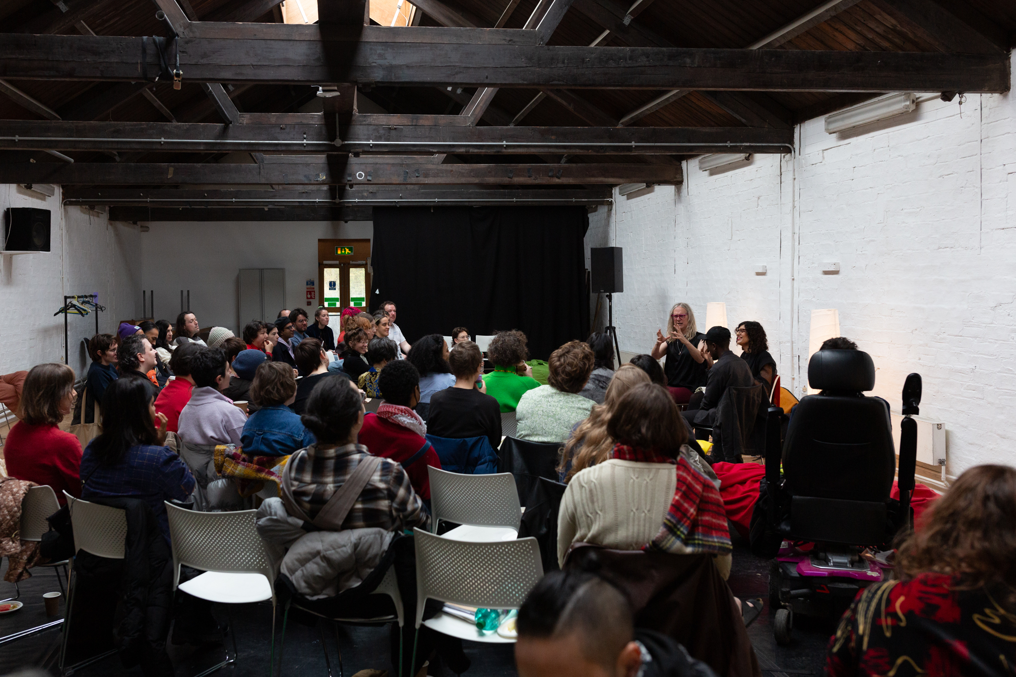 And audience face towards three speakers.